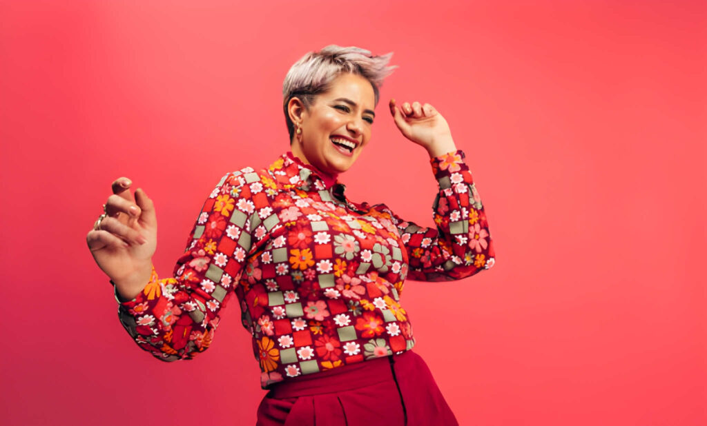 Joyful Lifestyle Portrait of a Woman Dancing in a Colorful Outfit