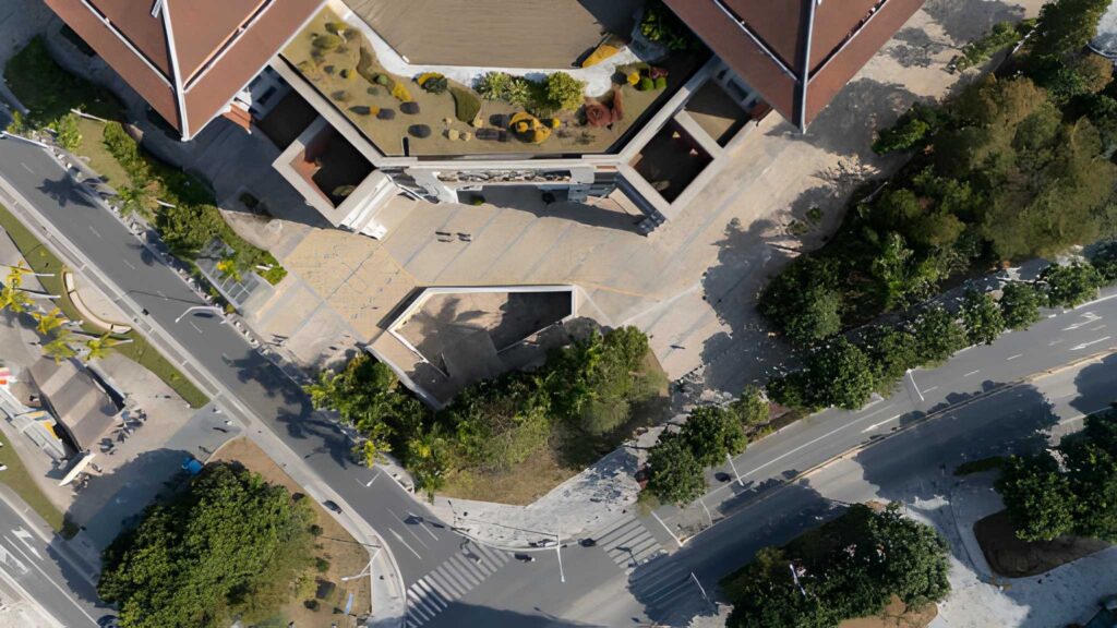 Top-down aerial view of modern buildings, landscaped areas, and intersecting roads captured from a bird’s-eye perspective