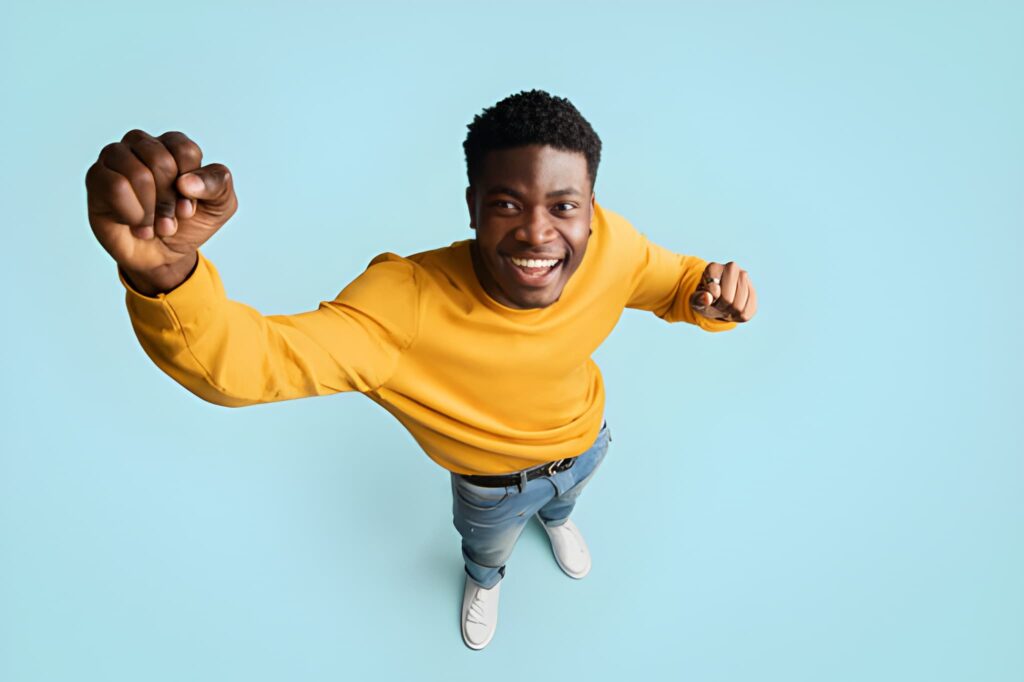 High-angle portrait photography showcasing positive emotion, confidence, and dynamic body language.