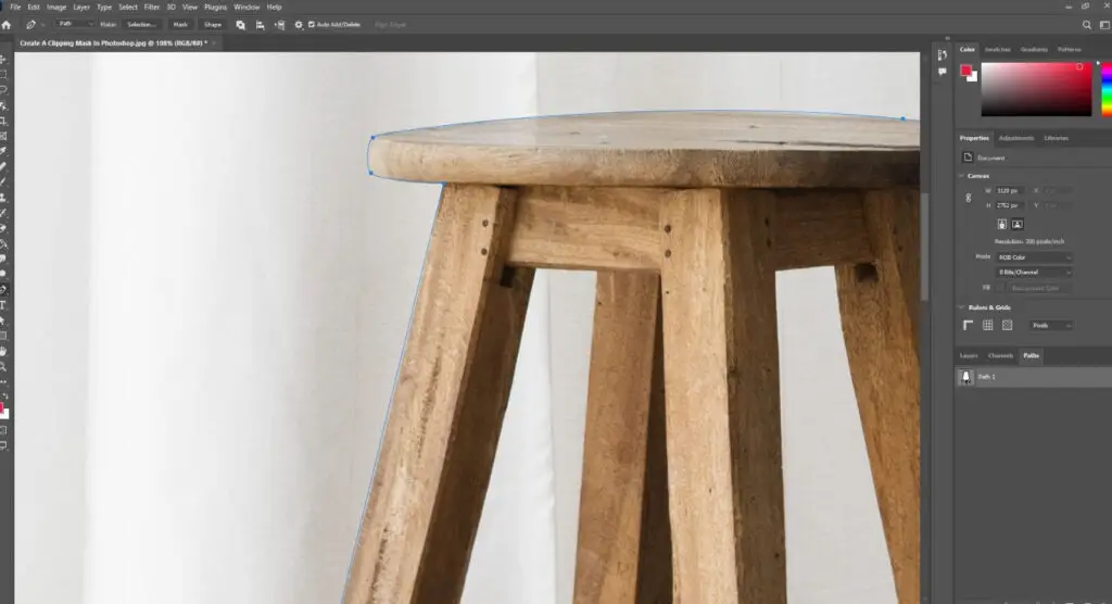 Close up image of wooden stool marked with blue line displayed in adobe photoshop interface.