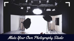 A photography studio setup featuring softboxes, a backdrop, and studio lighting equipment, with curtains on the side.