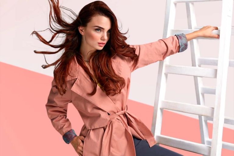 After Fashion & Beauty Retouching, the image features a woman in a pink trench coat elegantly posed against a ladder.