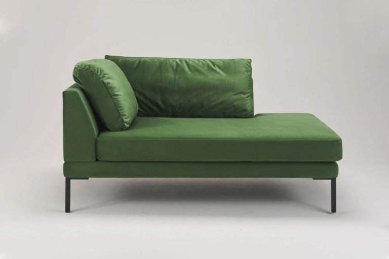 Green couch with black metal frame, modern design.