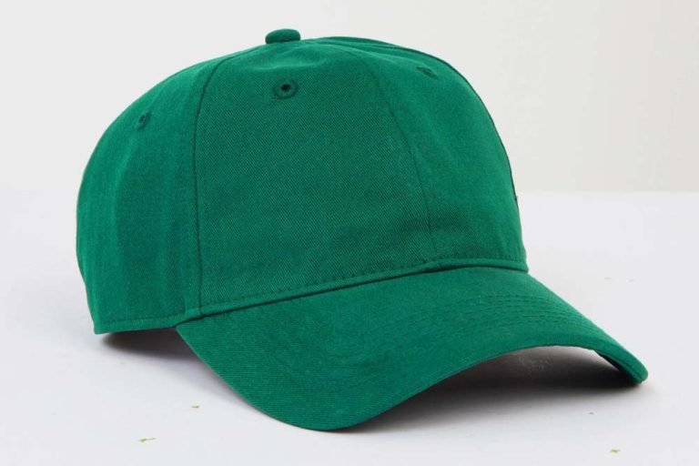 A green baseball cap on a white background before editing