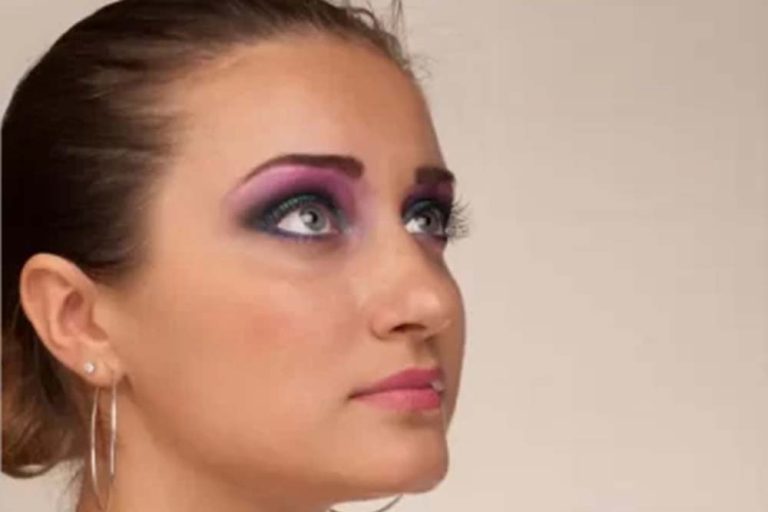 before high end retouching: A woman with vibrant purple and pink makeup, showcasing a bold and dark look.