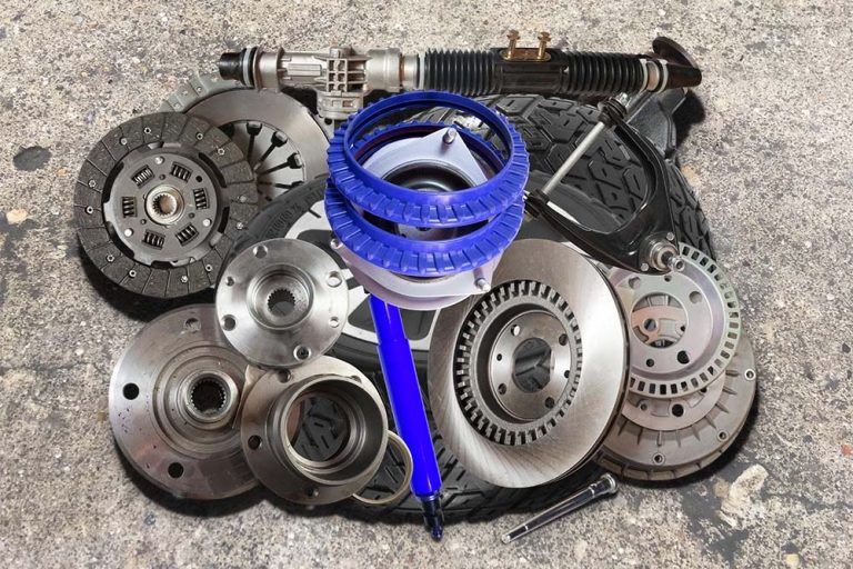 Various car parts and tools displayed on a white surface requires editing