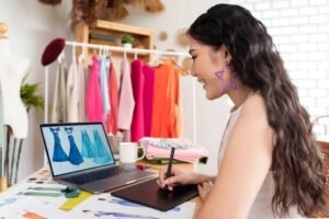 A girl is editing apparel product images for Amazon with Wacom connected to Macbook.