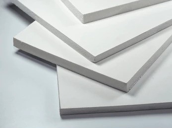 White Foam Board Sheets Stacked on Light Background