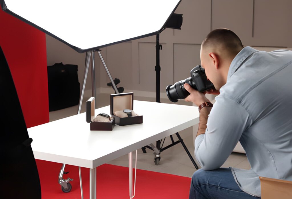 Professional photographer capturing a luxury wristwatch using studio lighting for eCommerce product photography.