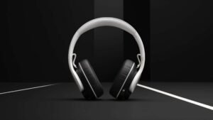 White headphones on a dark background with geometric lines.