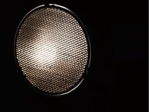 a close up of a grid light diffuser in the dark