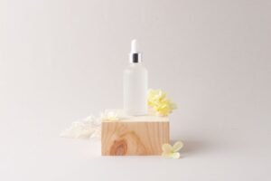 A bottle of liquid placed on a wooden block, showcasing a simple yet elegant arrangement by implementing the rule of thirds.