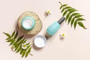 Cosmetic products arranged on a wooden stump, surrounded by daisies and white flowers, creating a natural and elegant display.