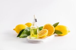 Lemon oil and essential oil bottles displayed on a clean white background, highlighting their vibrant colors and textures as flat lay photo backdrop.