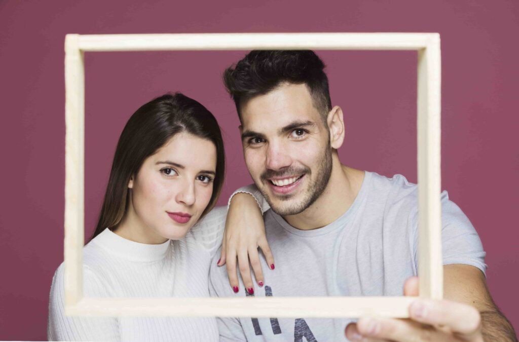 A couple taking pose using a frame