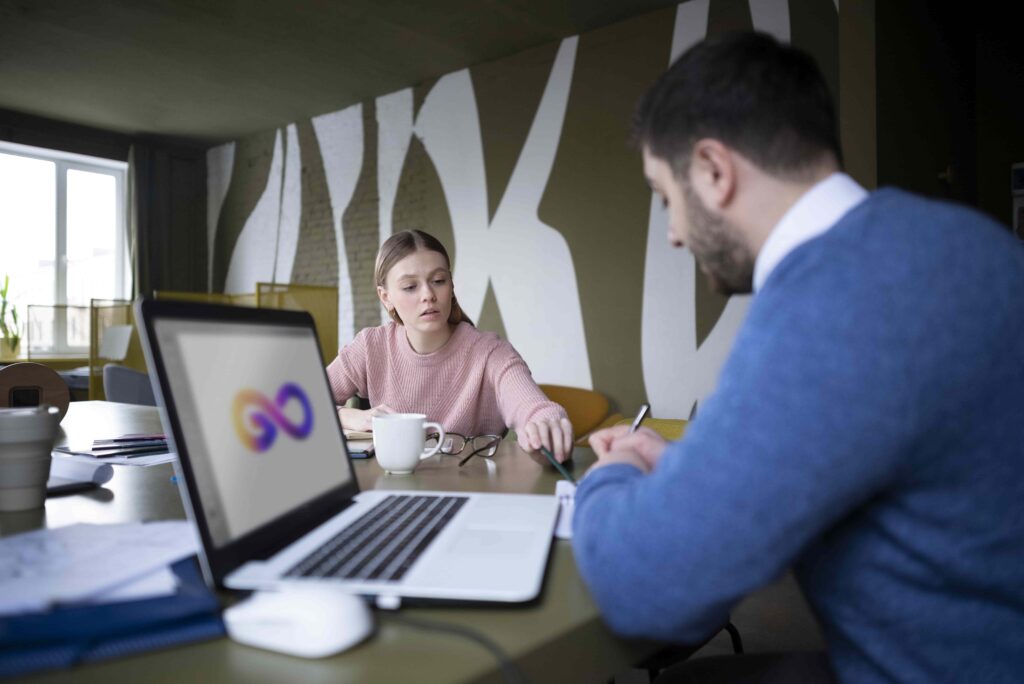 Team members discussing clipping path projects in a modern workspace, collaborating for high-quality image editing.