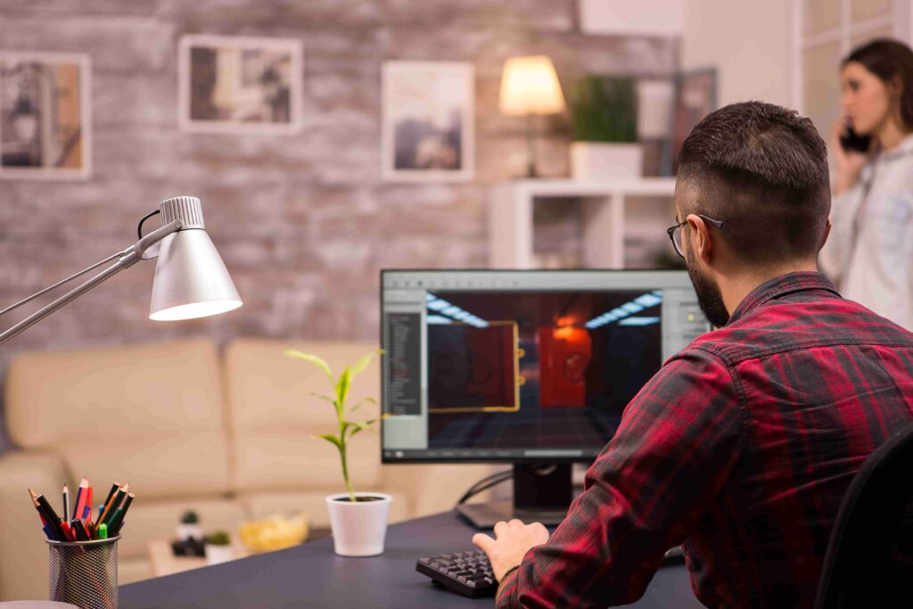 Graphic designer working on clipping path editing at computer in a creative workspace, showcasing expert image editing skills.