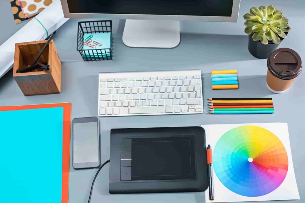 Modern creative workspace featuring computer and graphic tablet, tools used by photographers and designers to make money with photography.