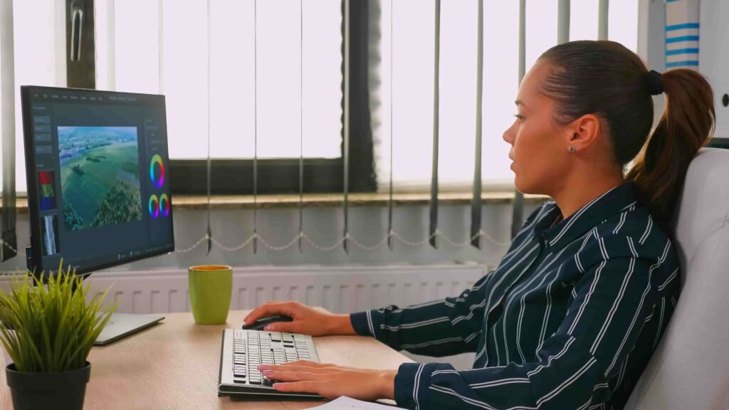 a girl using desktop for photo editing