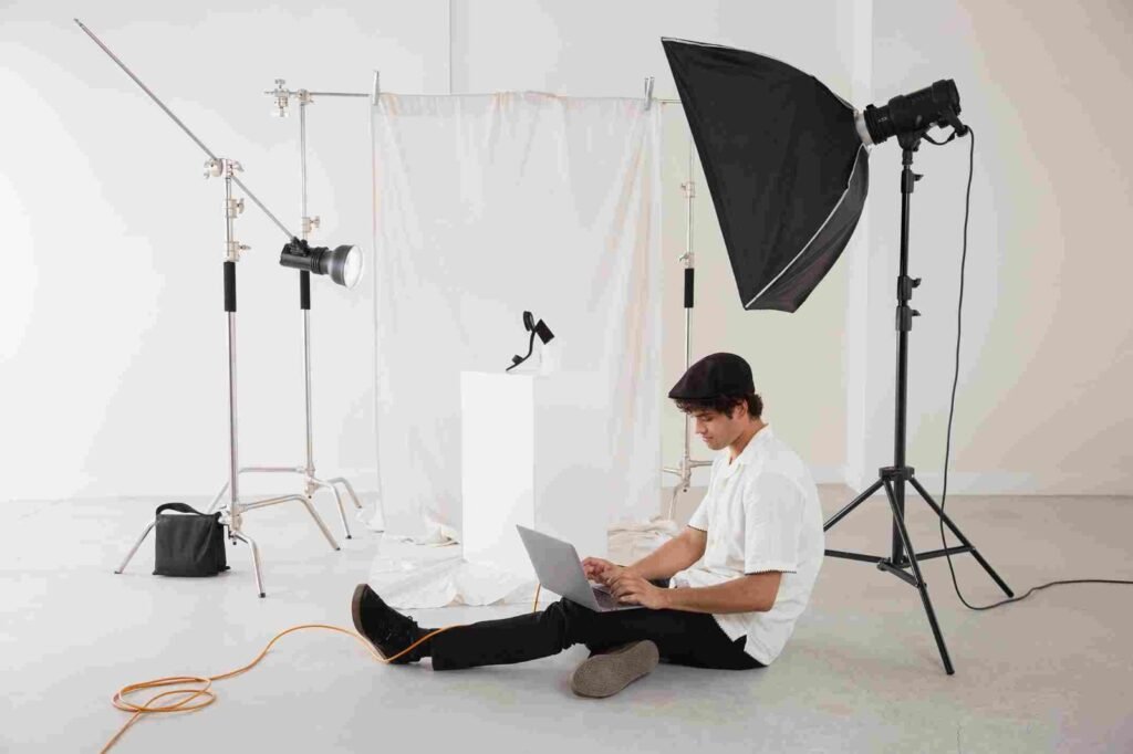 A man using laptop in a photo studio