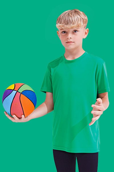 A young boy joyfully holds a ball, ready to play.
